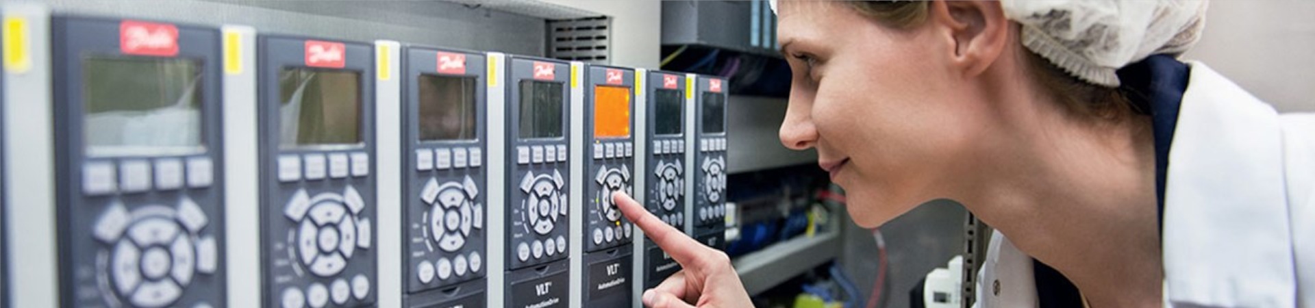Woman inspecting panel of FC-321 drives.